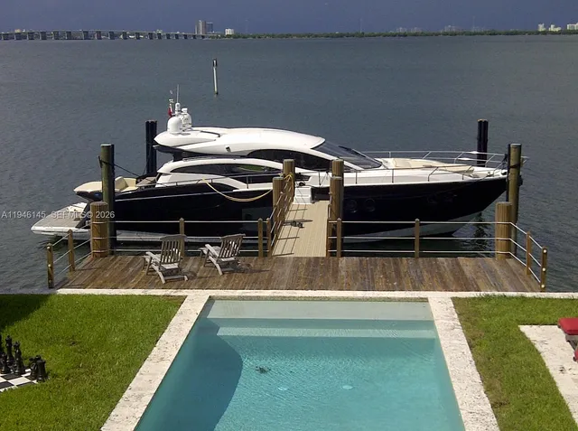 a view of a balcony with two chairs and a table