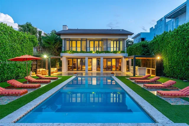 a view of an house with backyard space and balcony