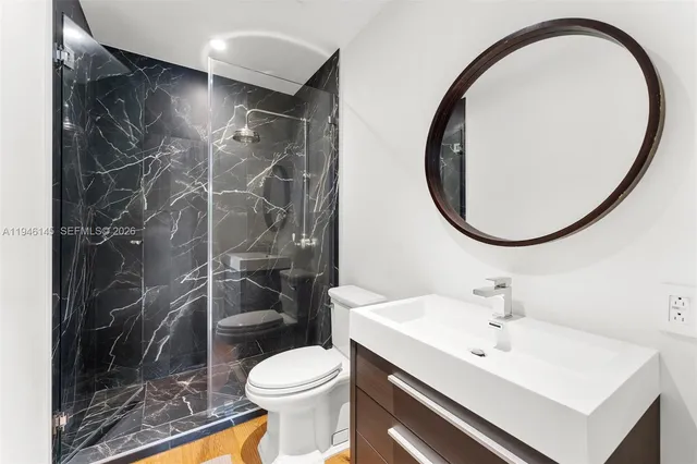 a bathroom with a sink toilet and a mirror