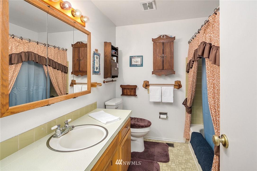 2708 Northeast 24th Street Renton, WA 98056 - Photo 14 of 14 a bathroom with a sink a mirror and a toilet