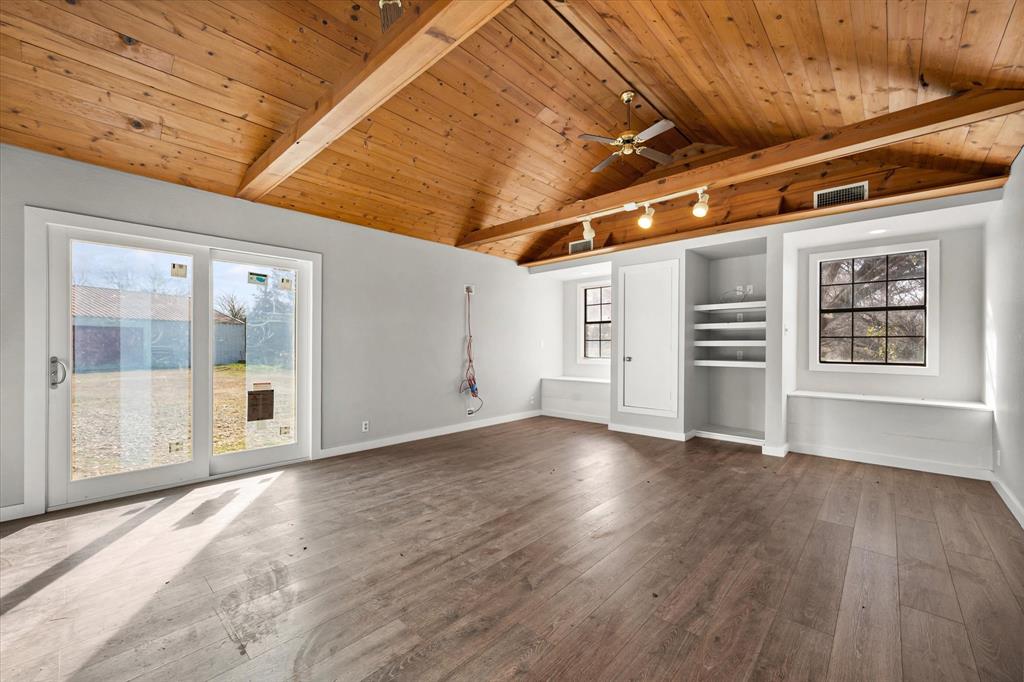 443 County Road 3799 Springtown, TX 76082 - Photo 8 of 33 Unfurnished living room featuring wood ceiling, dark wood-style floors, a ceiling fan, and built in shelves