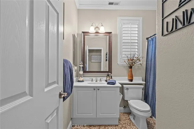 a bathroom with a sink toilet and mirror