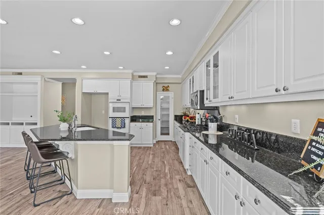 a kitchen with stainless steel appliances kitchen island granite countertop a sink and cabinets