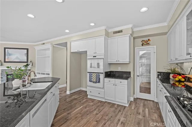 a kitchen with stainless steel appliances a stove a sink and a refrigerator