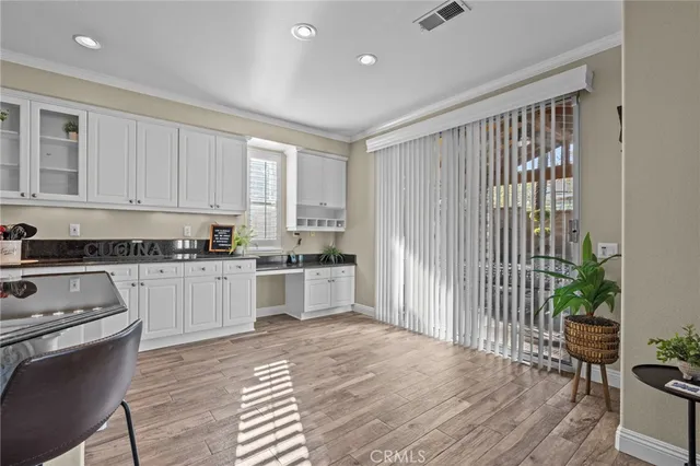 a kitchen with granite countertop white cabinets and white appliances