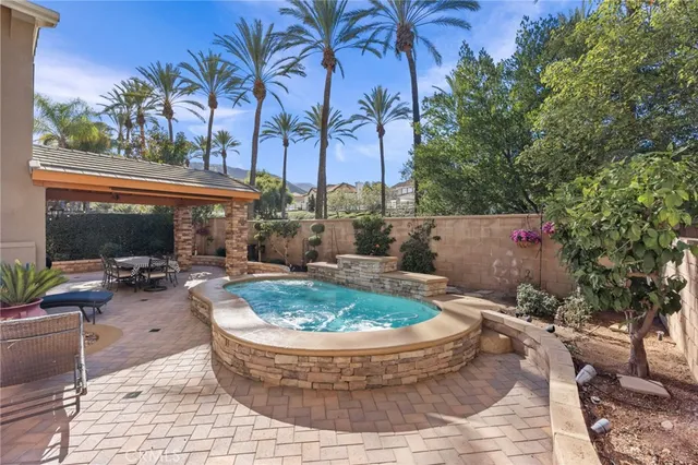 a view of a patio with a table and chairs under an umbrella