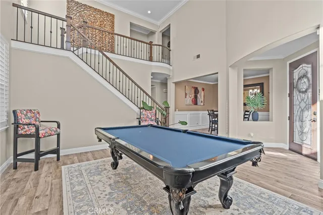 a room with pool table and windows