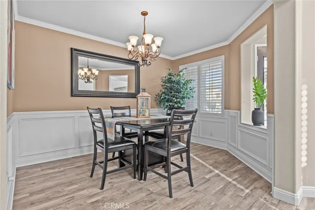 a view of a dining room with furniture and a chandelier