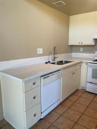 a kitchen with a sink cabinets and utility