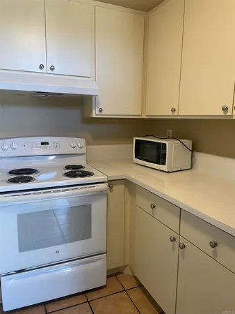 a stove top oven sitting inside of a kitchen