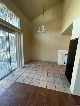 a view of wooden floor in a hall with an entryway