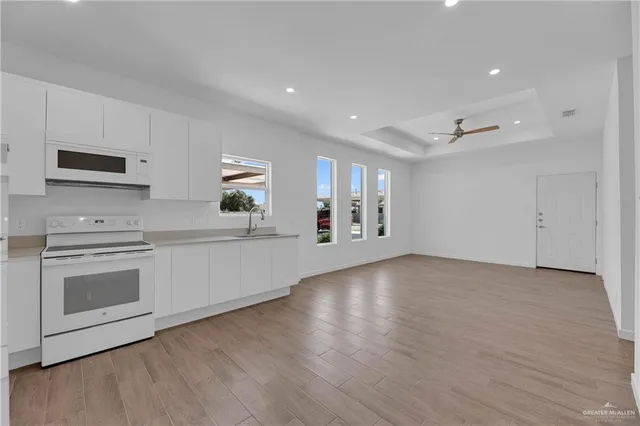 a view of a kitchen with a stove cabinets and a wooden floor