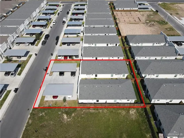 an aerial view of residential houses with outdoor space