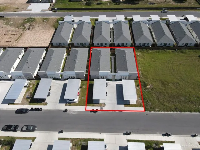 an aerial view of residential houses with outdoor space