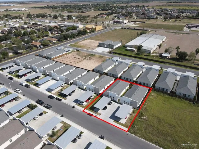 an aerial view of residential houses with outdoor space