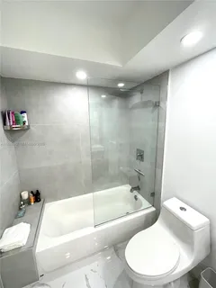 a bathroom with a toilet and bathtub