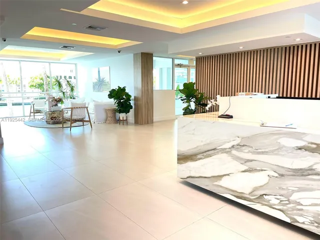 a lobby with furniture and a potted plant