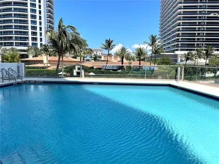 a view of swimming pool with outdoor seating and city view