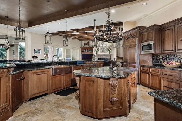 a kitchen with stainless steel appliances granite countertop a sink and stove