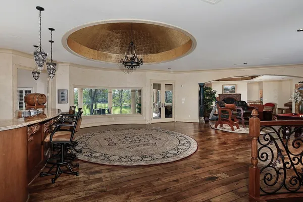a bedroom with a bed couch and a large window