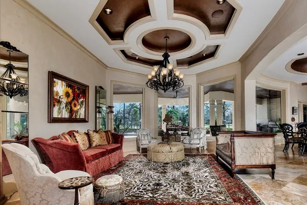 a living room with furniture and a chandelier