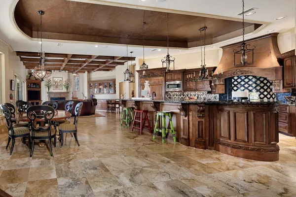 a kitchen with granite countertop a stove a sink and a microwave