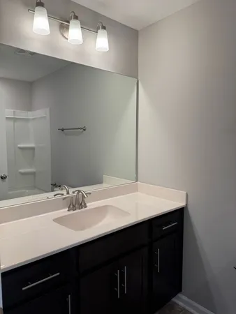 a white toilet and tub sitting next to a bathroom sink