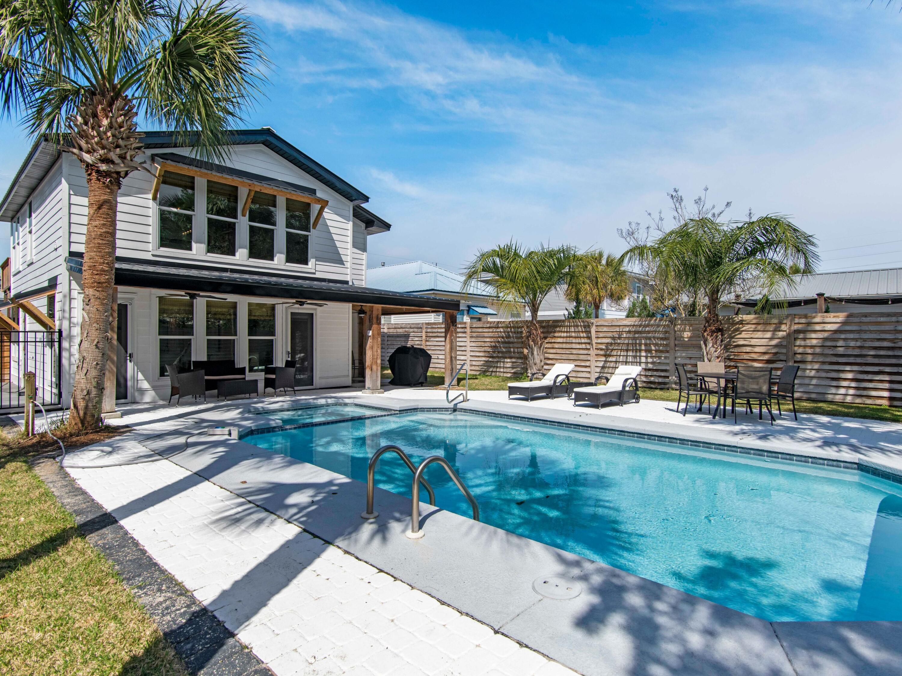 89 Tarpon Street Destin, FL 32541 - Photo 20 of 53 a front view of a house with swimming pool having outdoor seating
