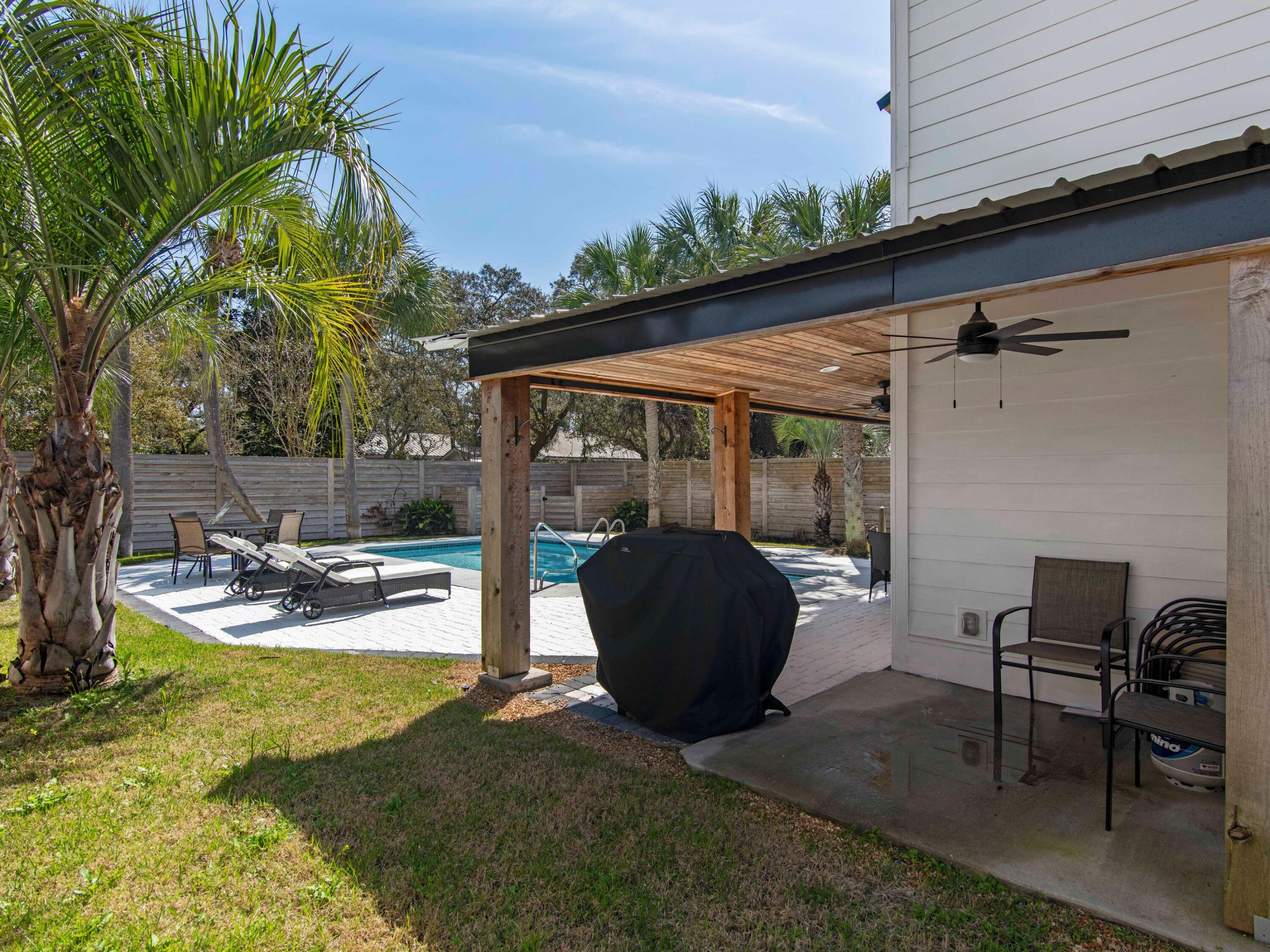 89 Tarpon Street Destin, FL 32541 - Photo 23 of 53 a view of a patio with table and chairs and potted plants