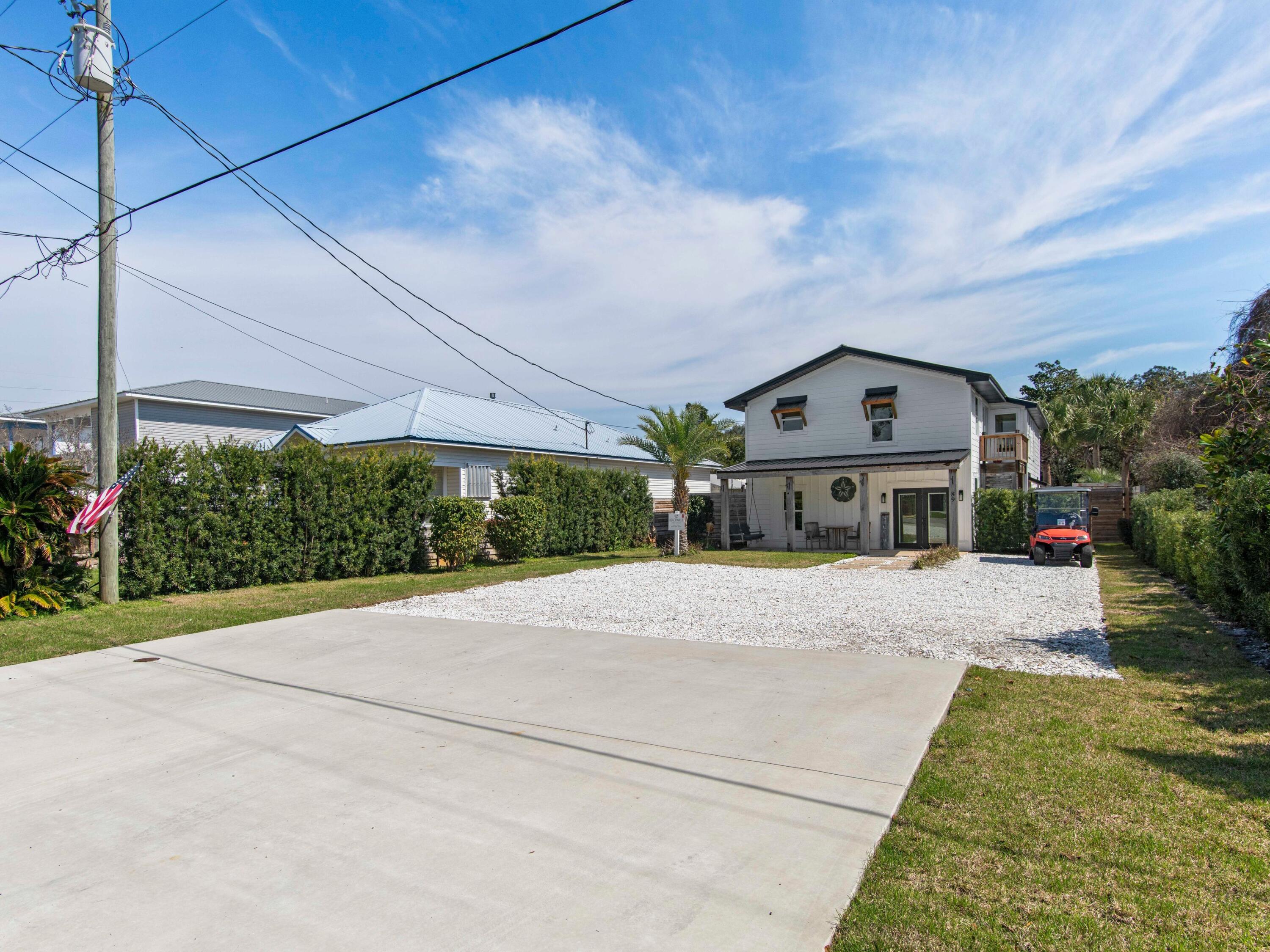 89 Tarpon Street Destin, FL 32541 - Photo 24 of 53 a front view of a house with a yard and potted plants