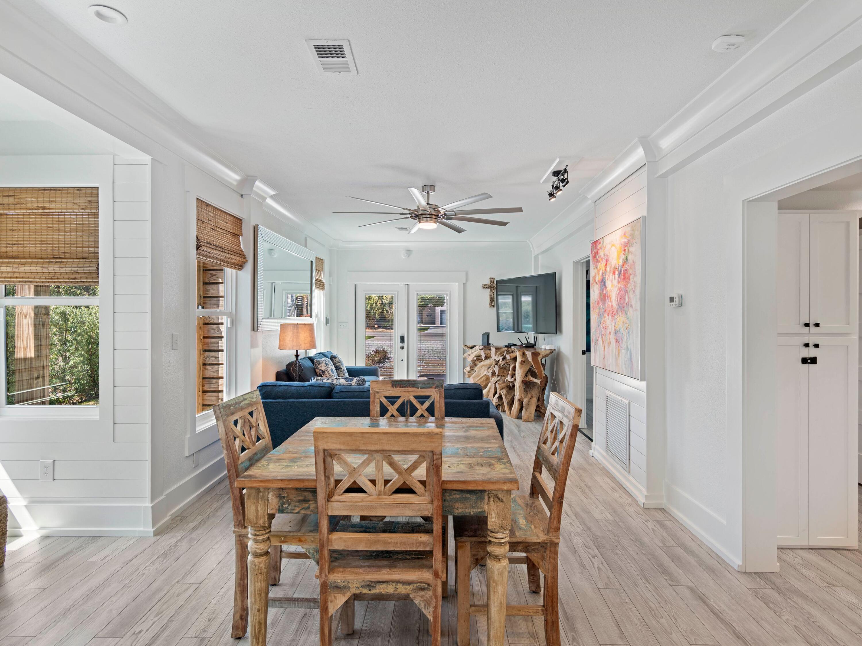 89 Tarpon Street Destin, FL 32541 - Photo 29 of 53 a view of a dining room with furniture window and wooden floor