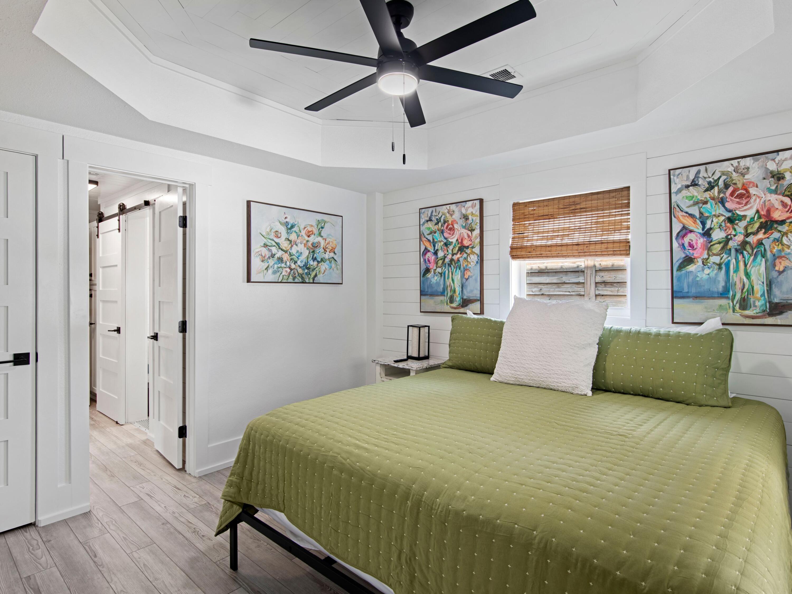 89 Tarpon Street Destin, FL 32541 - Photo 37 of 53 a bedroom with a large bed and a chandelier