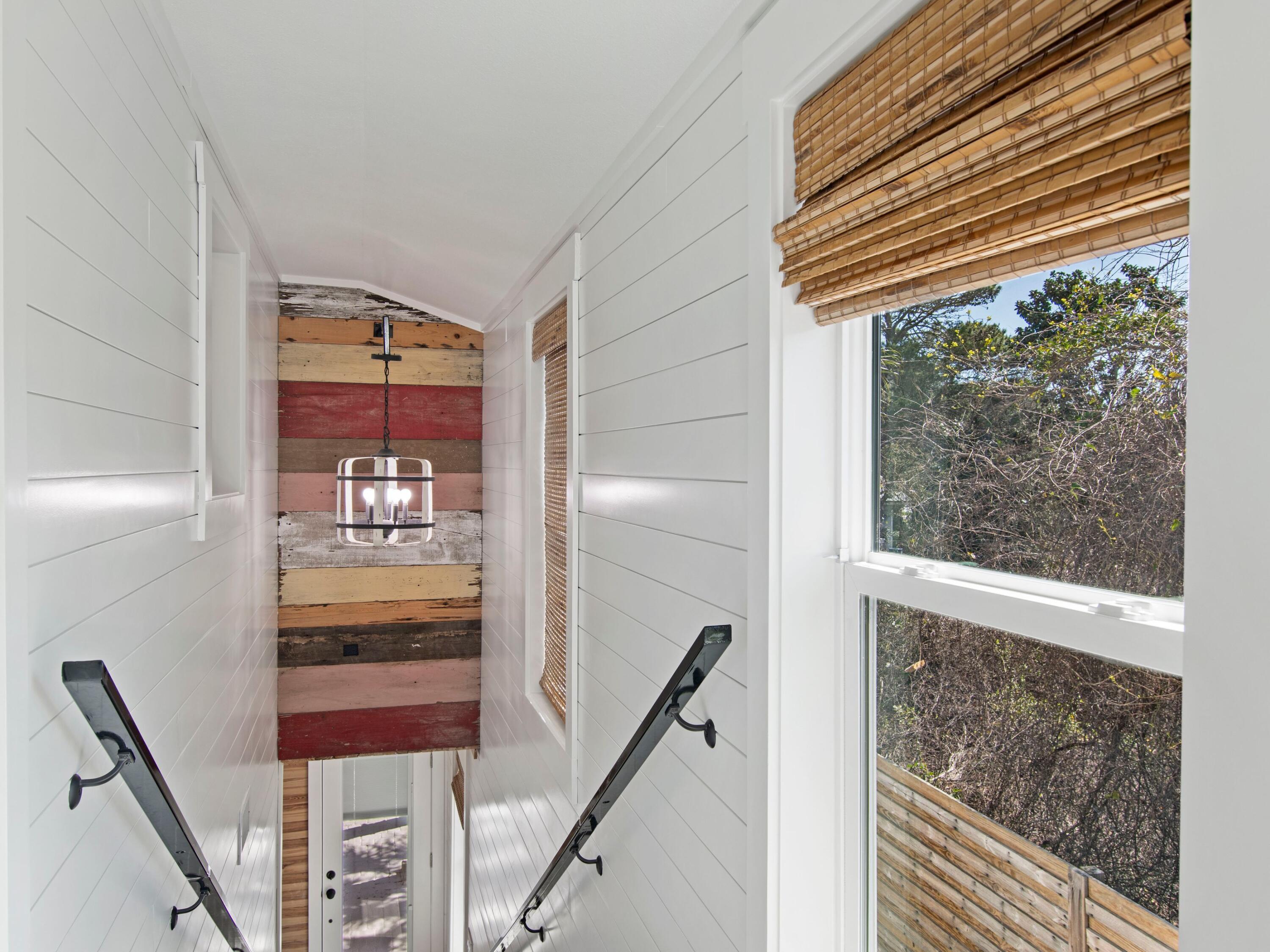 89 Tarpon Street Destin, FL 32541 - Photo 40 of 53 a view of a hallway with wooden floor and staircase