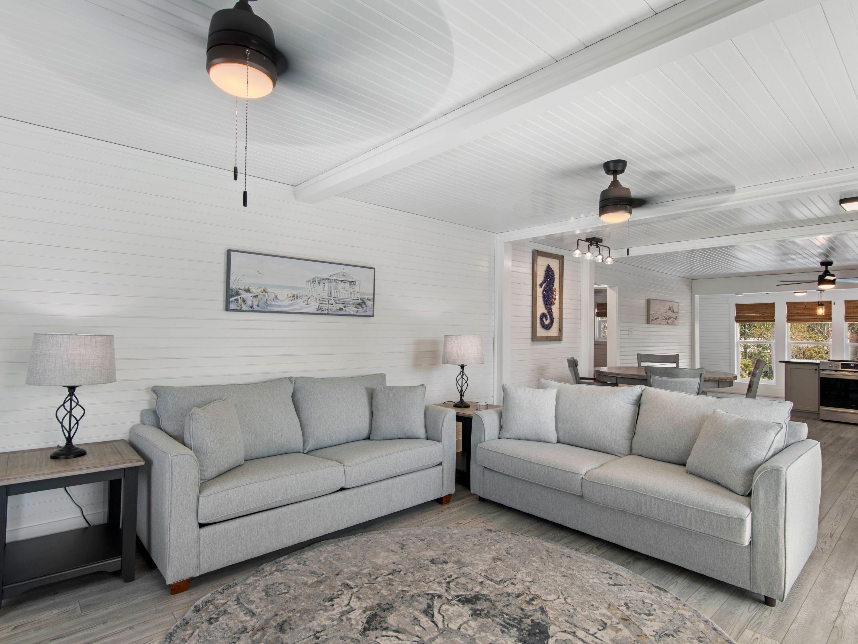 89 Tarpon Street Destin, FL 32541 - Photo 42 of 53 a living room with furniture and a chandelier