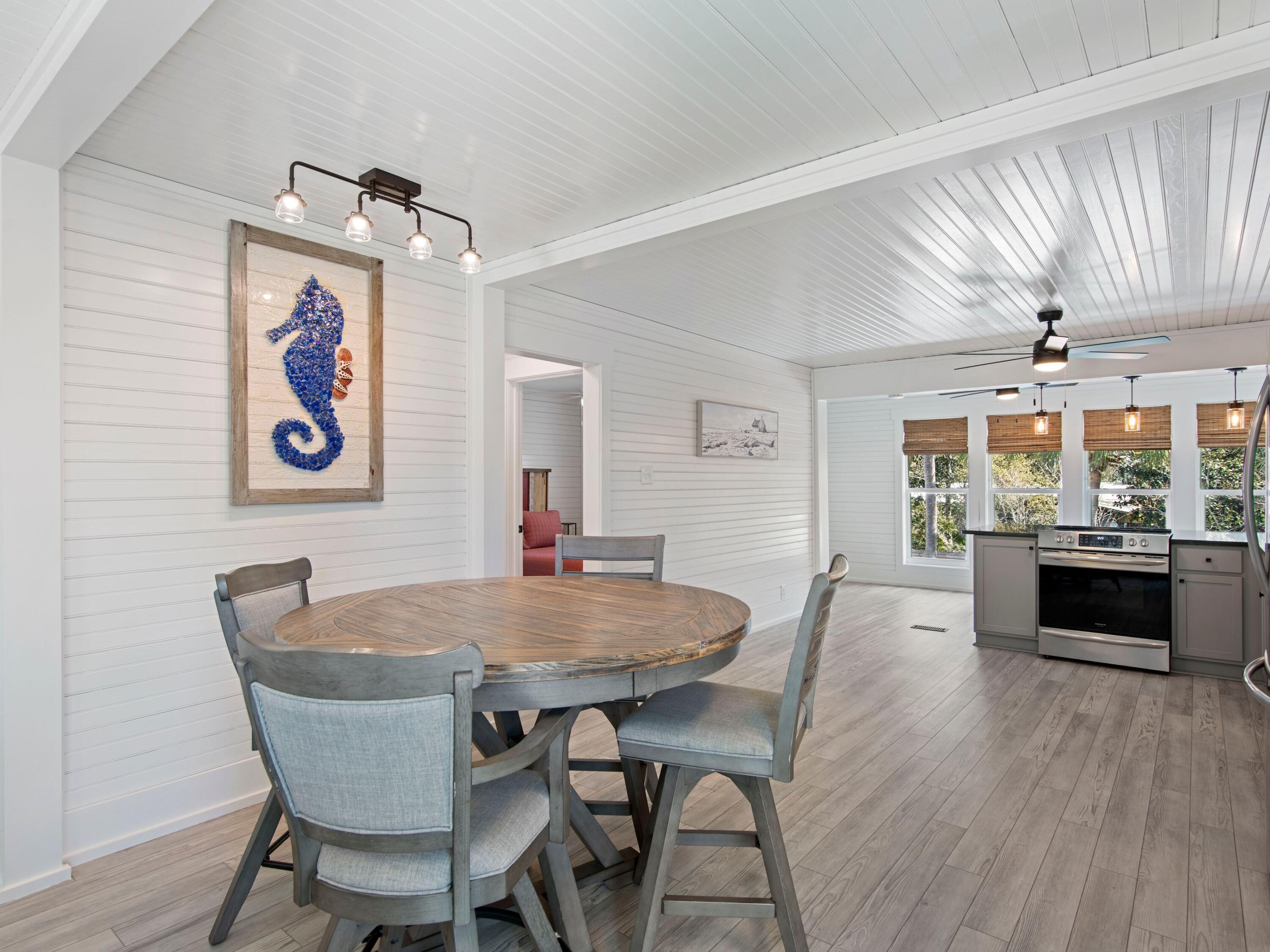 89 Tarpon Street Destin, FL 32541 - Photo 43 of 53 a view of a dining room with furniture window and wooden floor