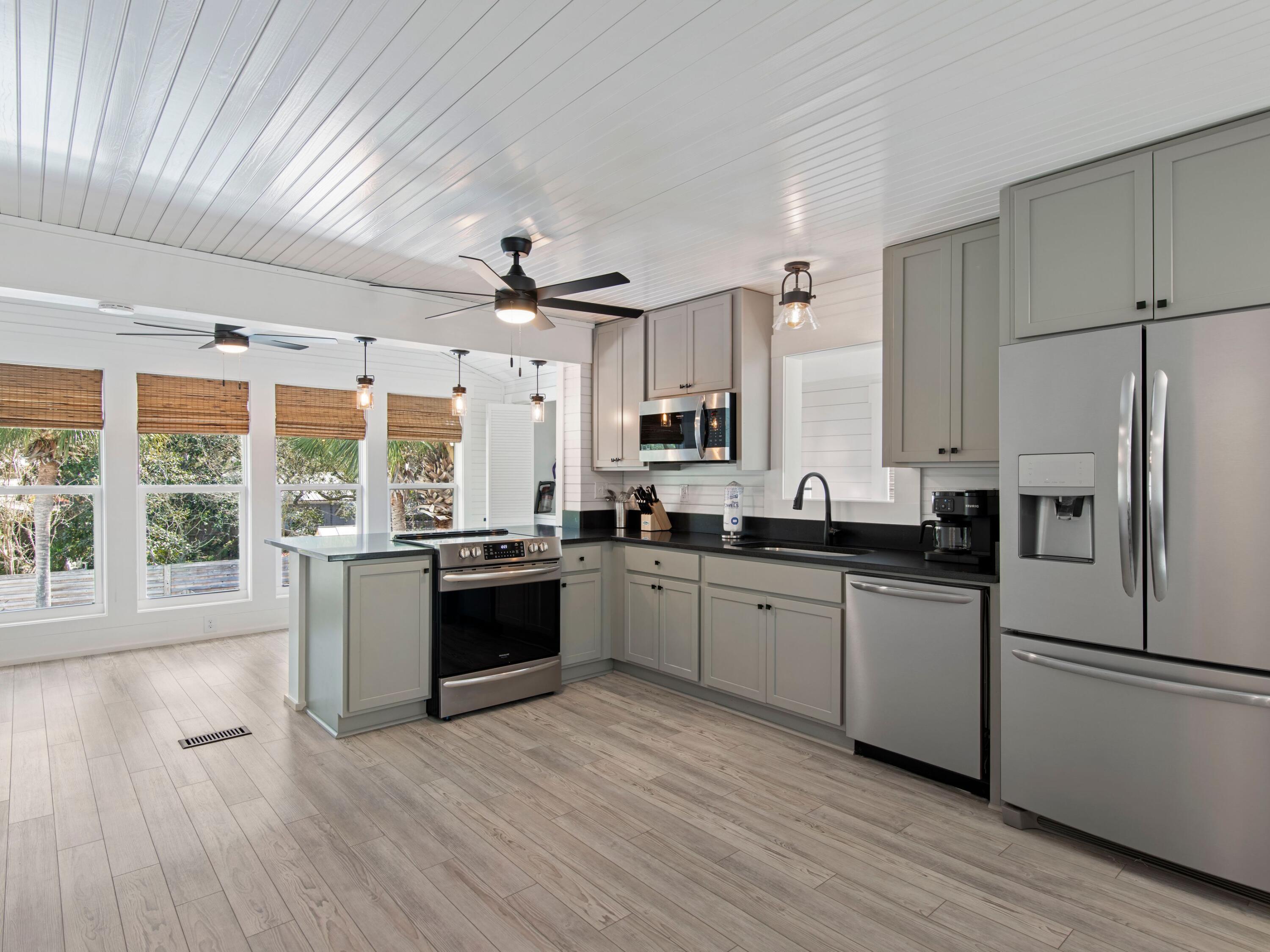 89 Tarpon Street Destin, FL 32541 - Photo 44 of 53 a large kitchen with a large window a sink and stainless steel appliances