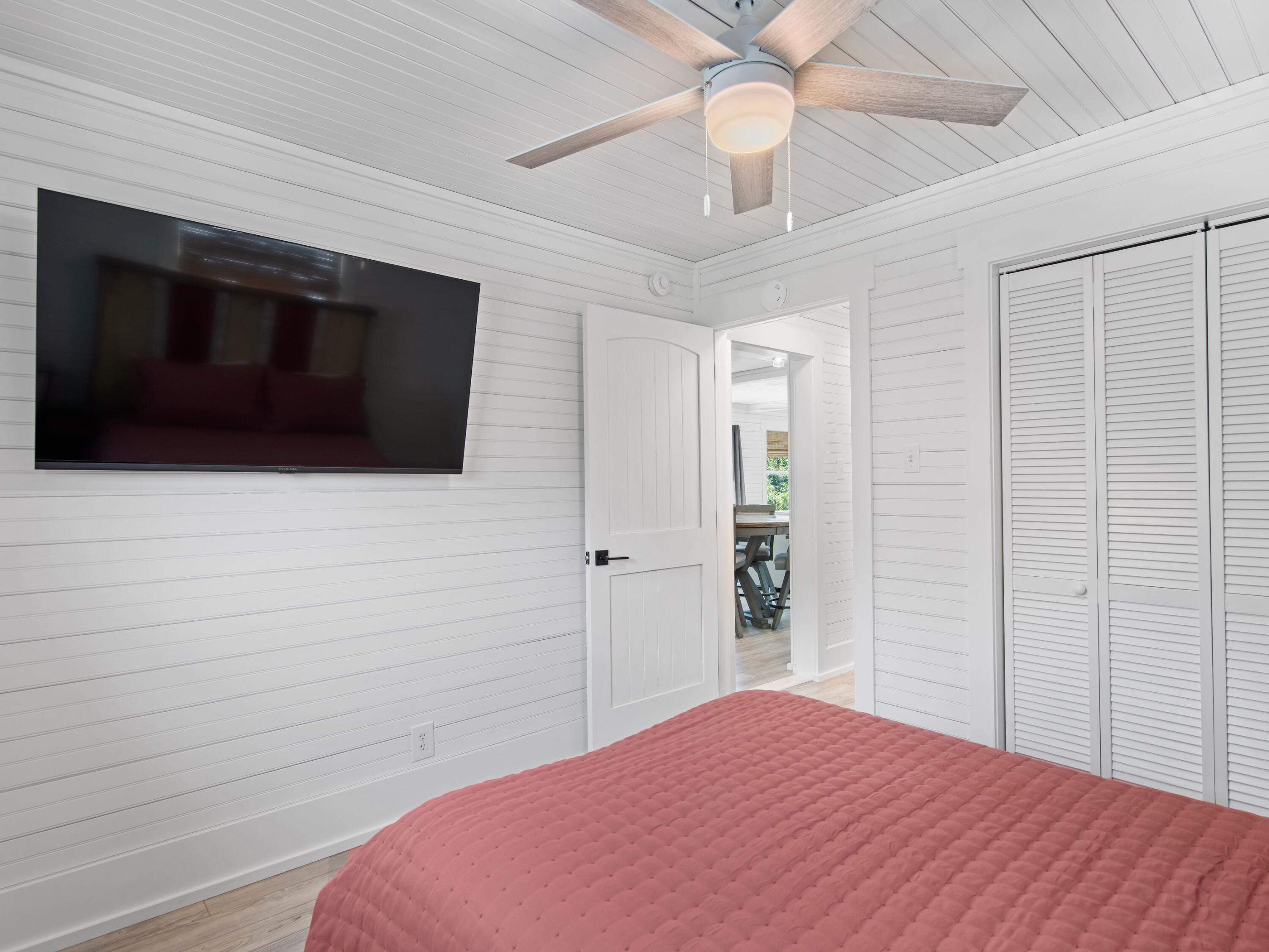 89 Tarpon Street Destin, FL 32541 - Photo 48 of 53 a bedroom with a bed and a flat tv screen