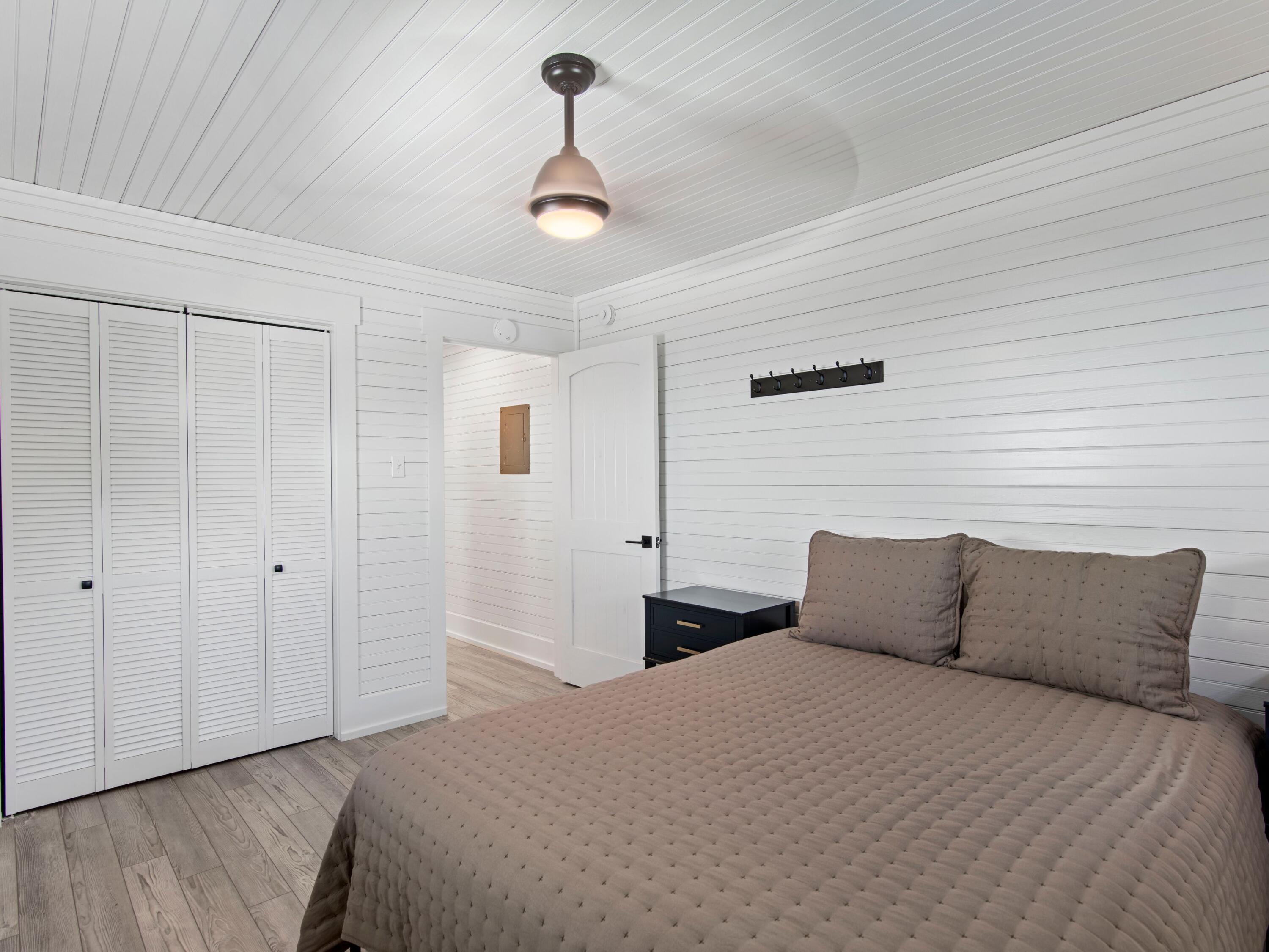 89 Tarpon Street Destin, FL 32541 - Photo 51 of 53 a bedroom with a bed and wooden floor