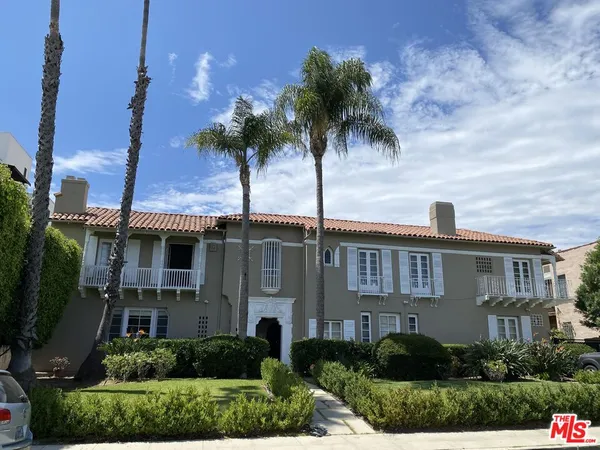 a front view of multiple houses with yard