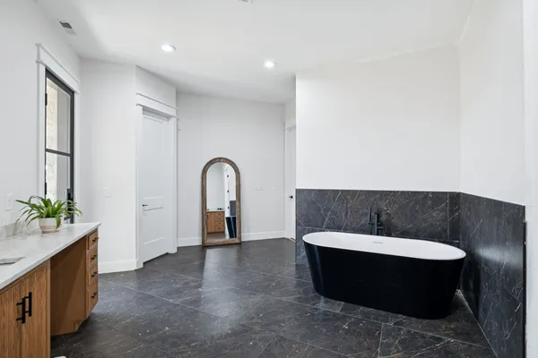 a kitchen with stainless steel appliances cabinets and a wooden floor