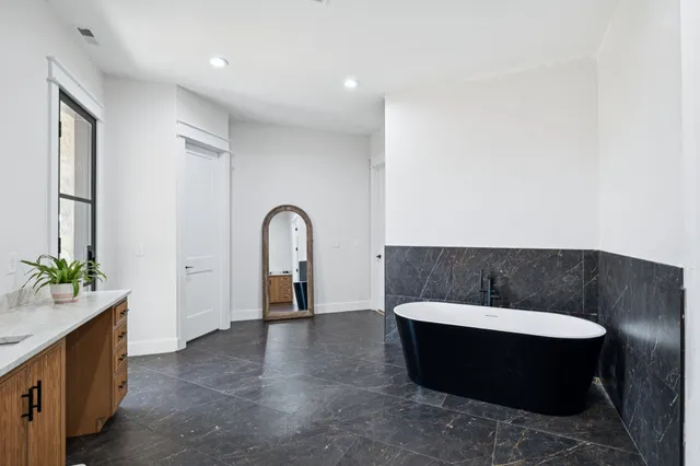 a kitchen with stainless steel appliances cabinets and a wooden floor