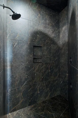 a stone bench sitting next to a wooden floor