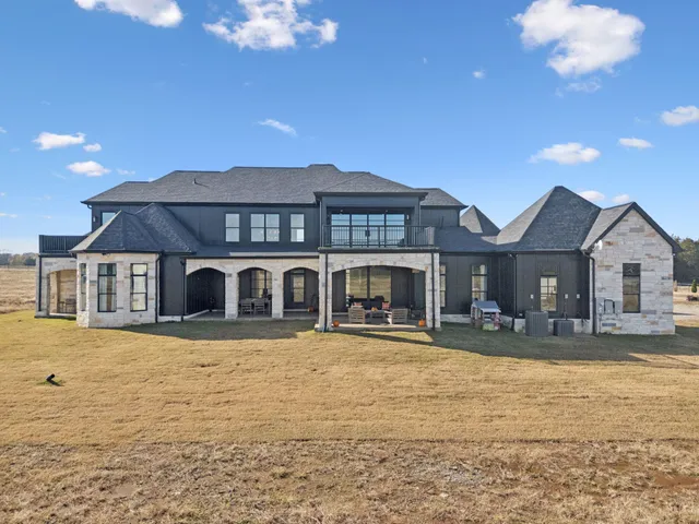 a roof deck with couches and potted plants