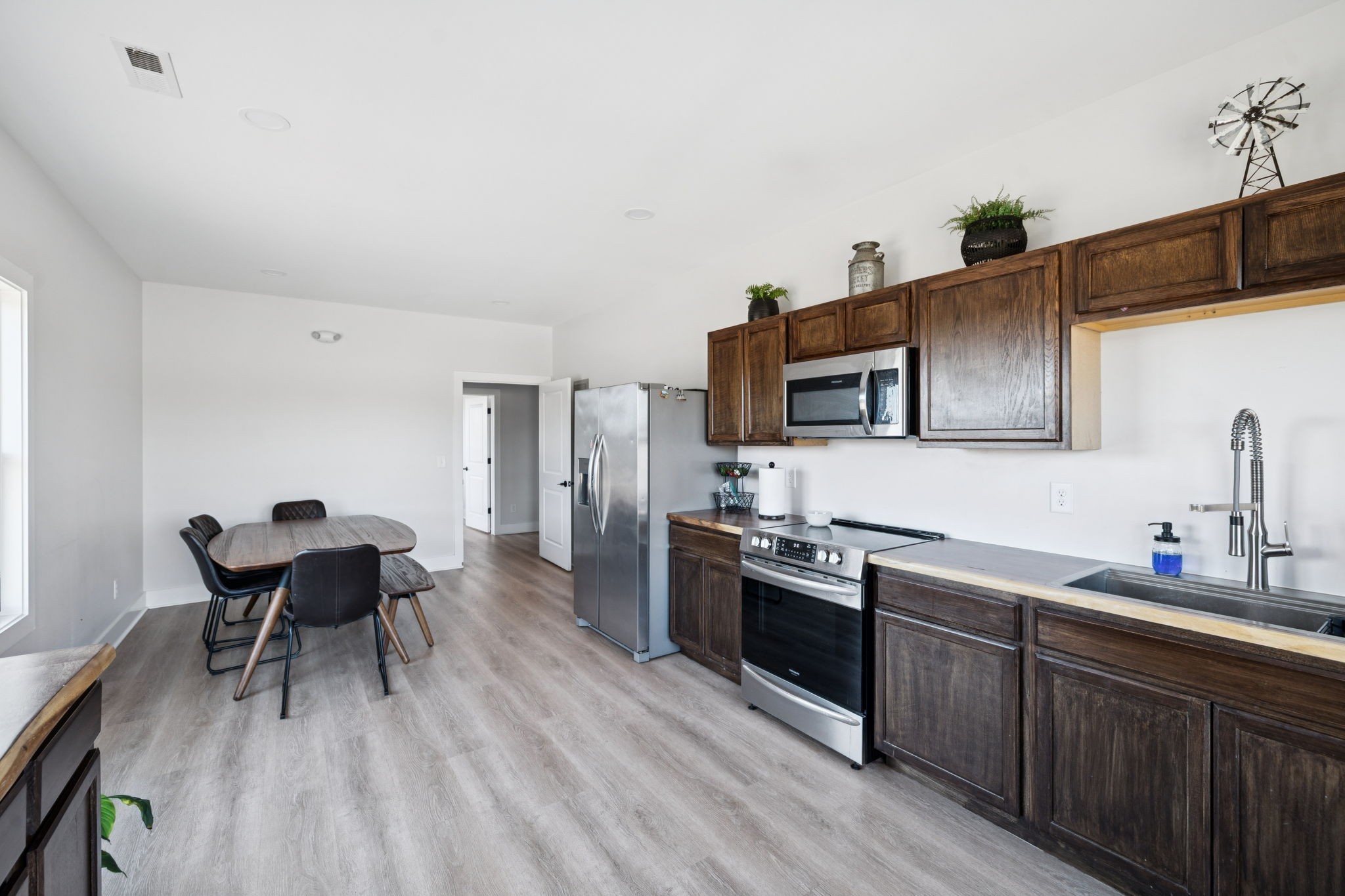 201 Lamb Road Rockvale, TN 37153 - Photo 72 of 87 a kitchen with stainless steel appliances granite countertop a stove top oven a sink dishwasher and white cabinets with wooden floor