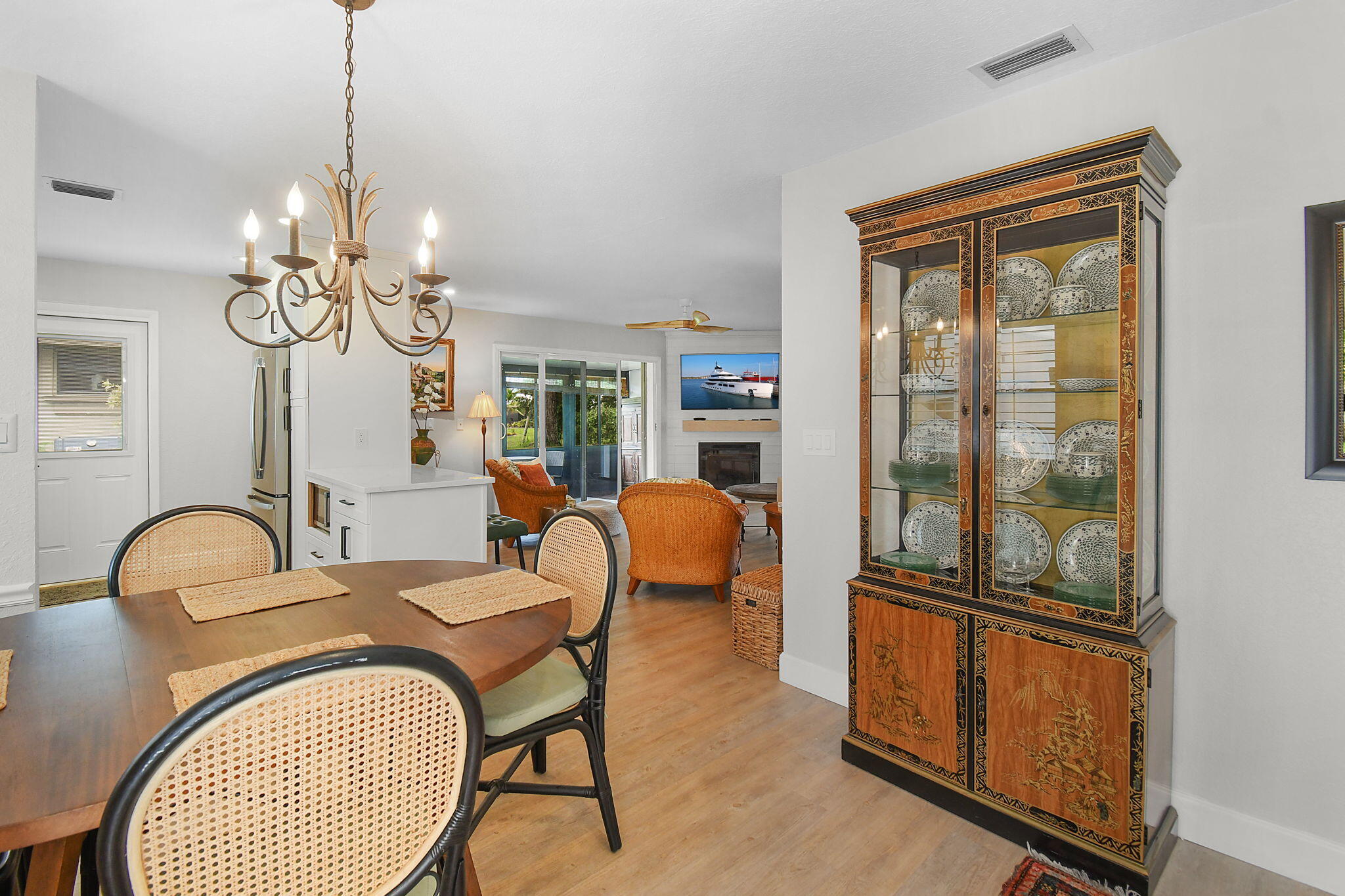 5251 Southeast Sea Island Way Stuart, FL 34997 - Photo 1 of 68 a dining room with furniture a chandelier and window