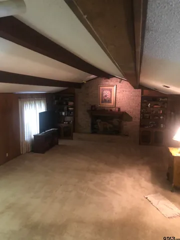 a view of hallway with a door and stairs