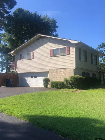 a view of a house with a yard and a garden