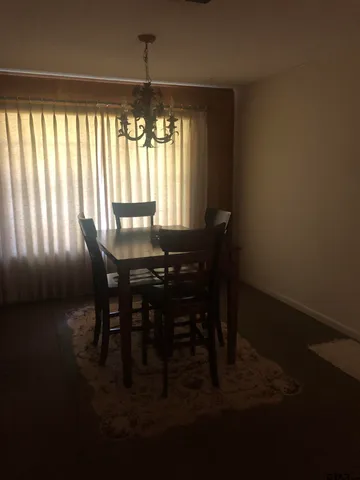 a view of a dining room with furniture and window