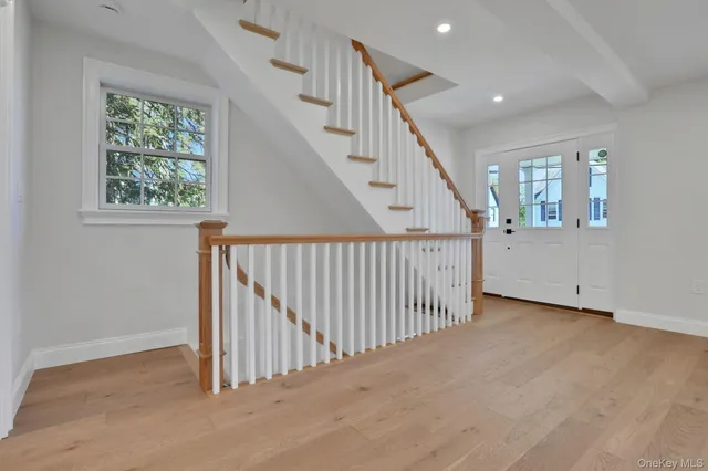 a view of kitchen with kitchen island white cabinets and stainless steel appliances
