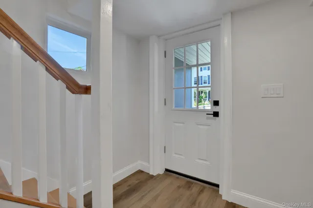 a view of entryway with wooden floor and stairs
